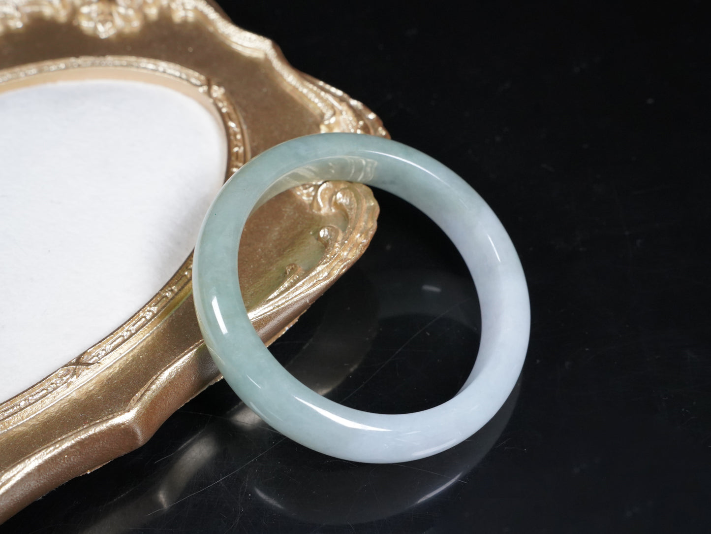 A half white half pale green dual tone  jadeite bangle.