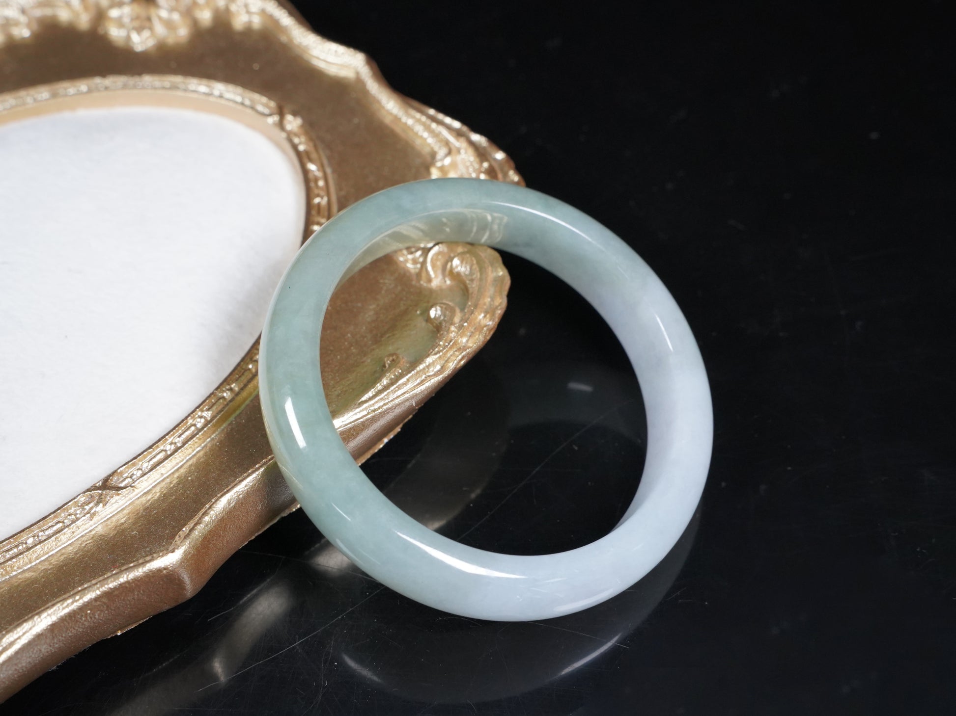 A half white half pale green dual tone  jadeite bangle.