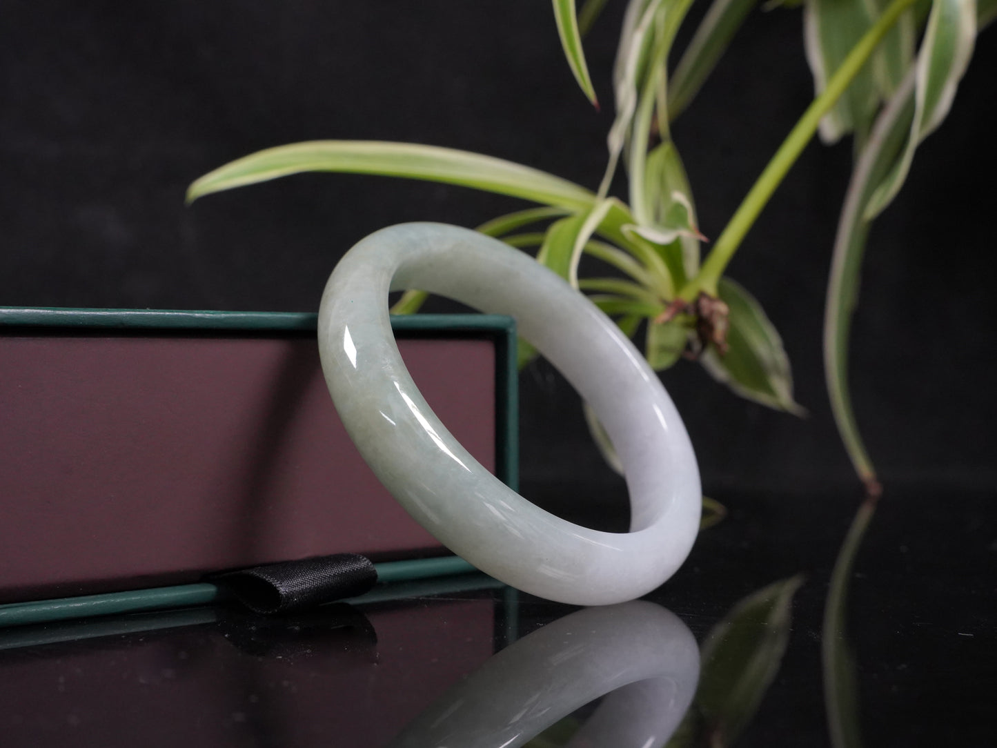 A half white half pale green dual tone  jadeite bangle.