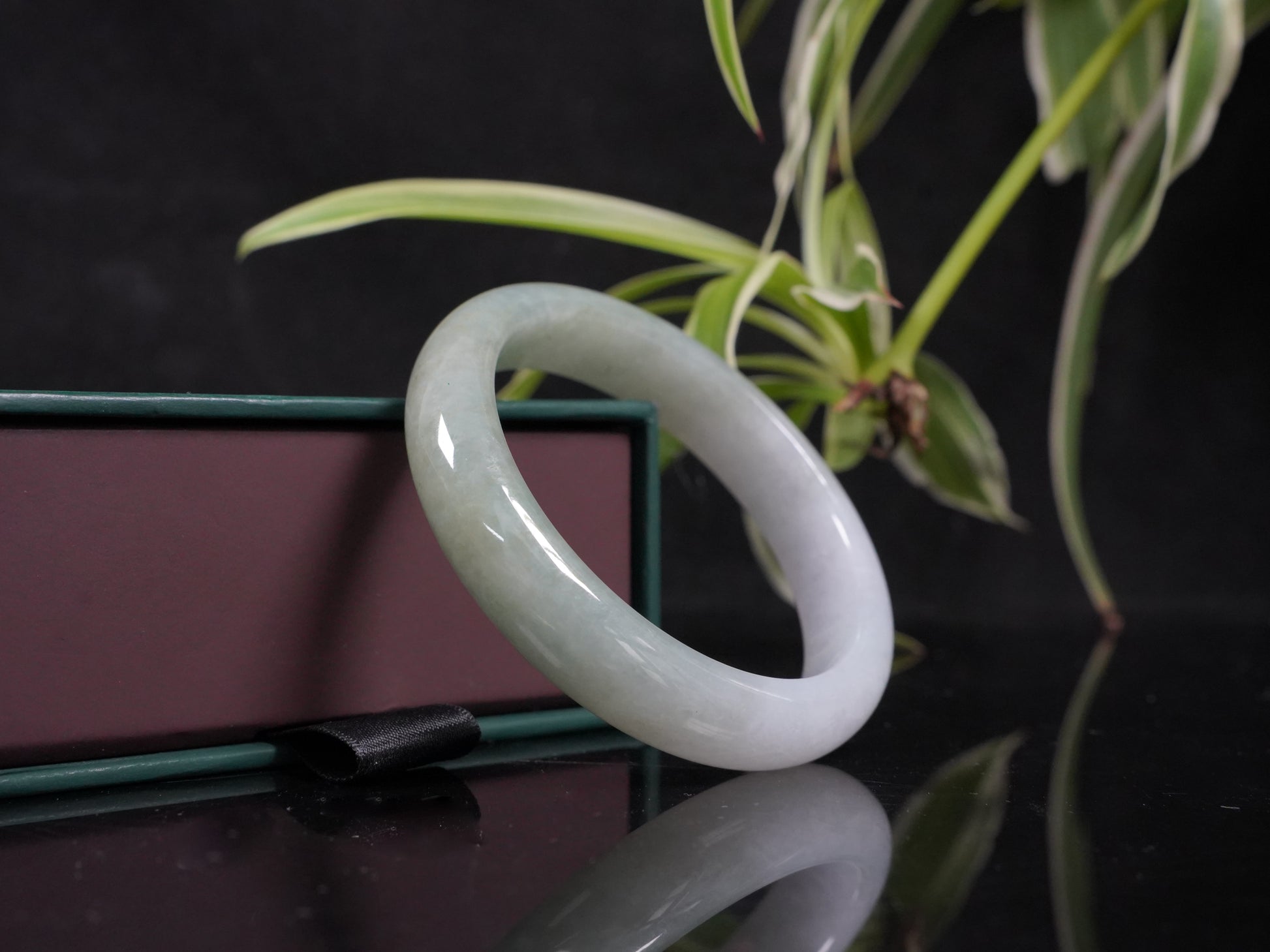 A half white half pale green dual tone  jadeite bangle.