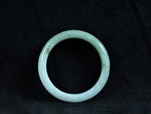 Green jade ring on a black background