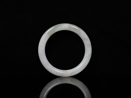 A milky white with soft green veins  jadeite bangle.