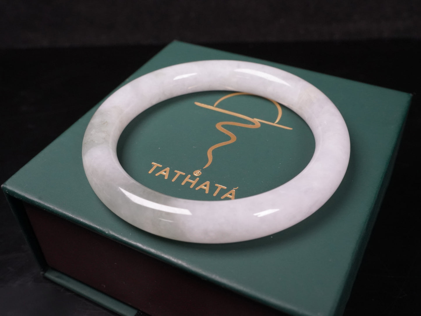 A milky white with soft green veins  jadeite bangle.