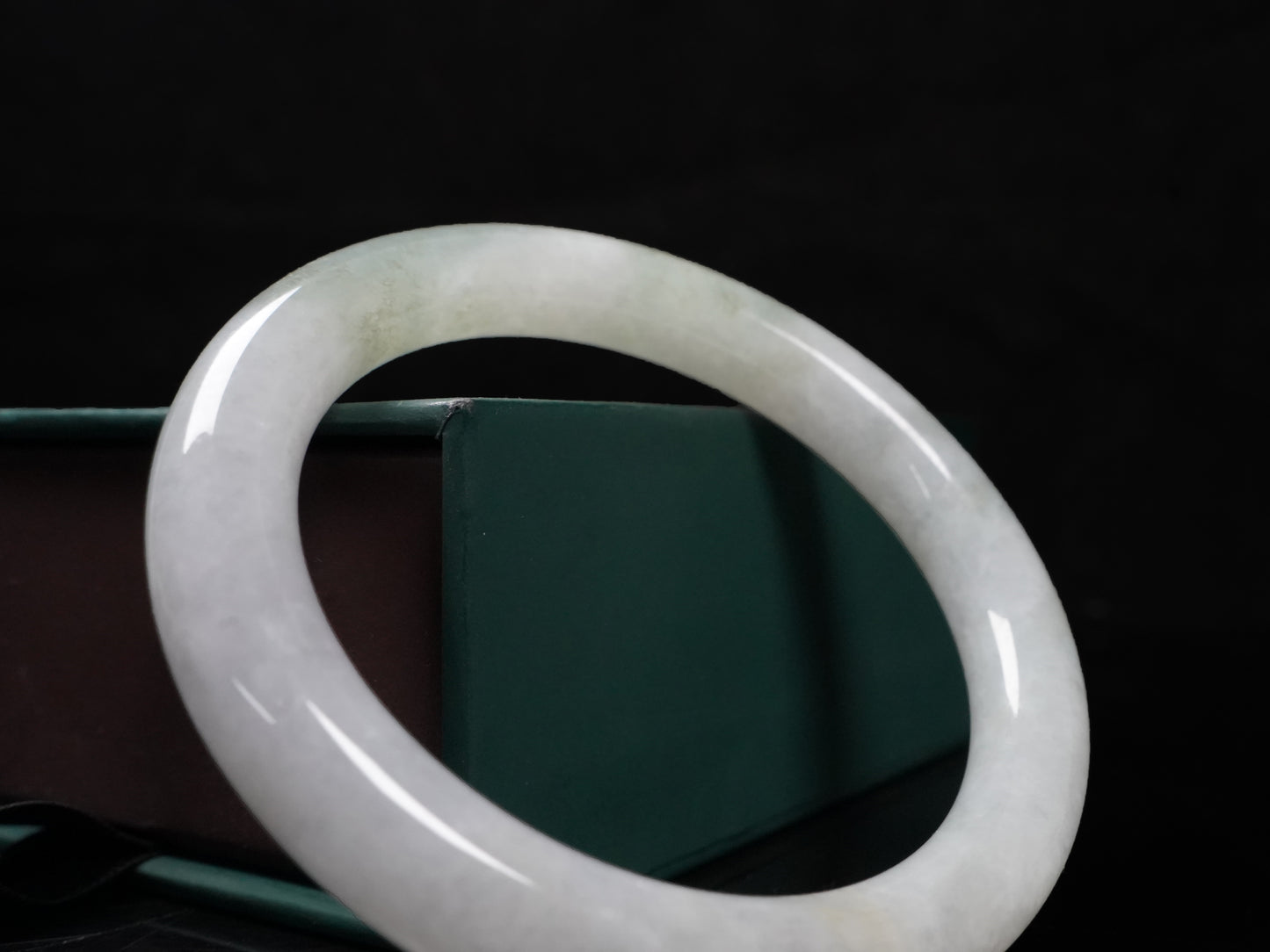 A milky white with soft green veins  jadeite bangle.