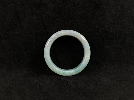 Green jade ring on a black background