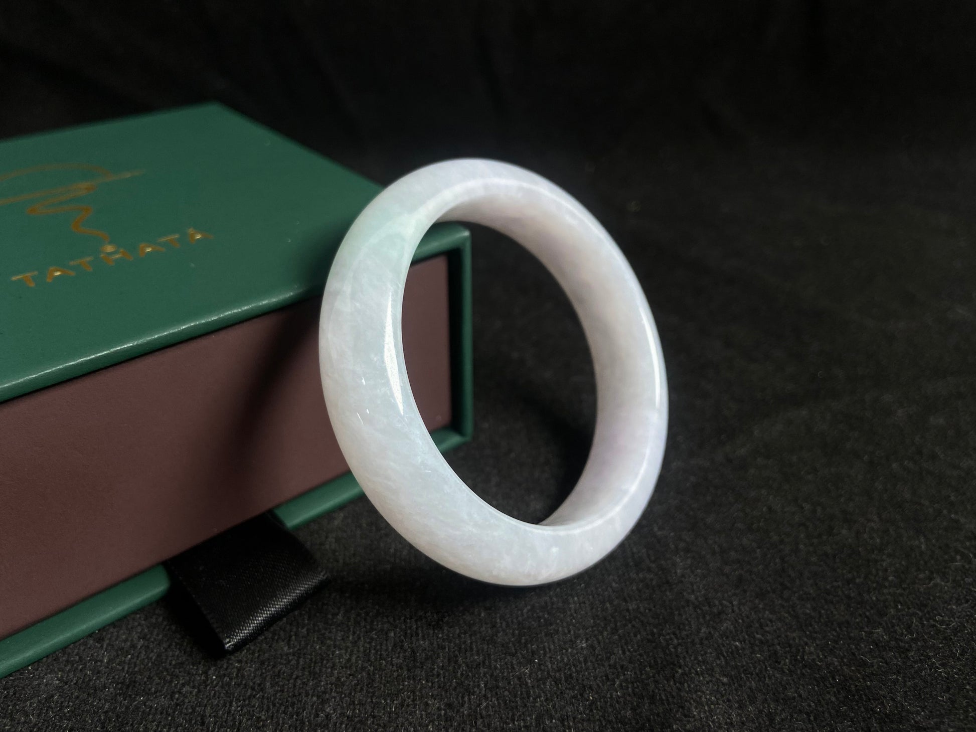 This jade bangle features a creamy white oval shaped Guifei design, known for its elegant and comfortable fit.