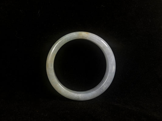Translucent jade ring on a black background
