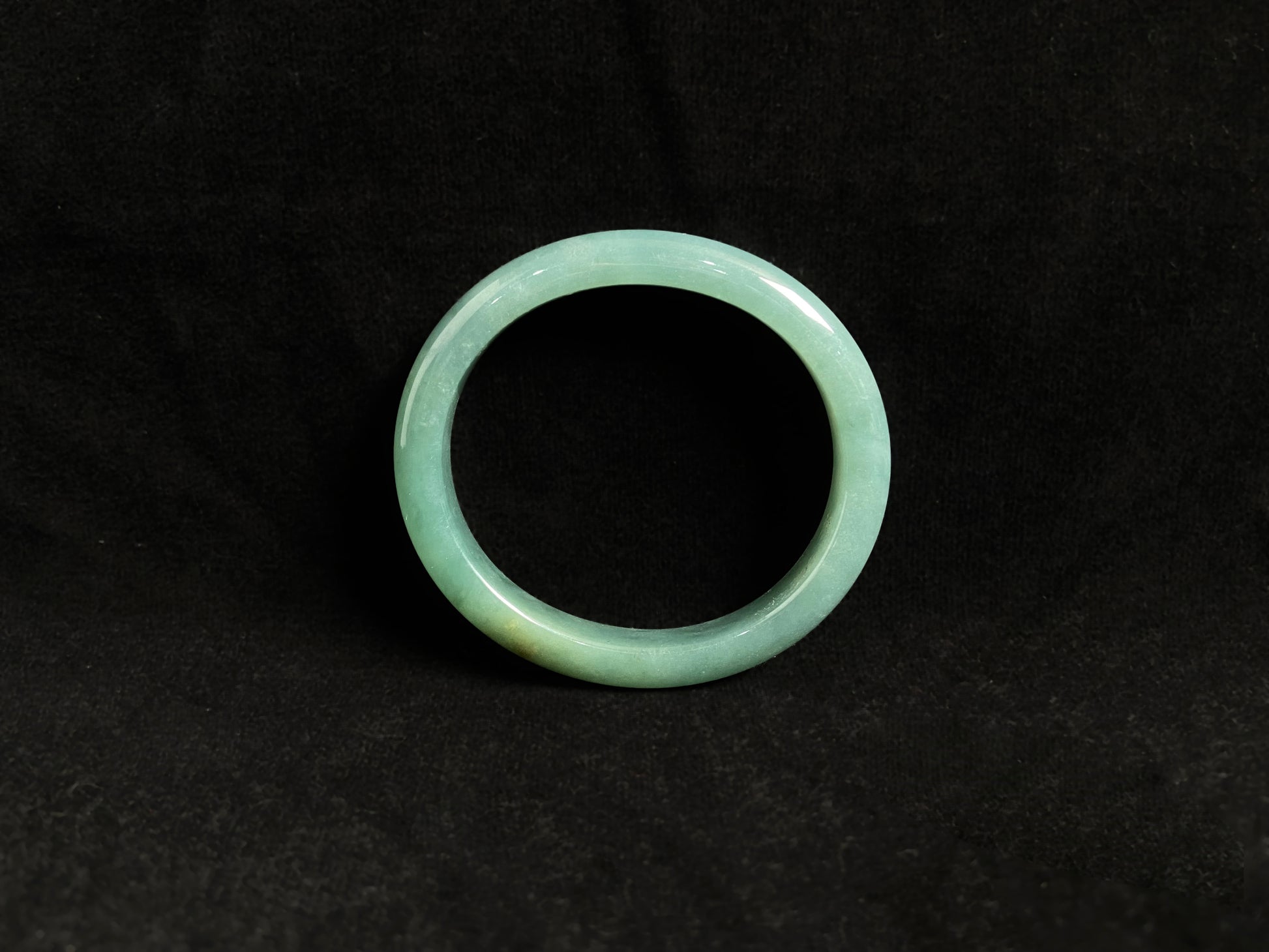 Deep green jade bangle with gold sprinkles.