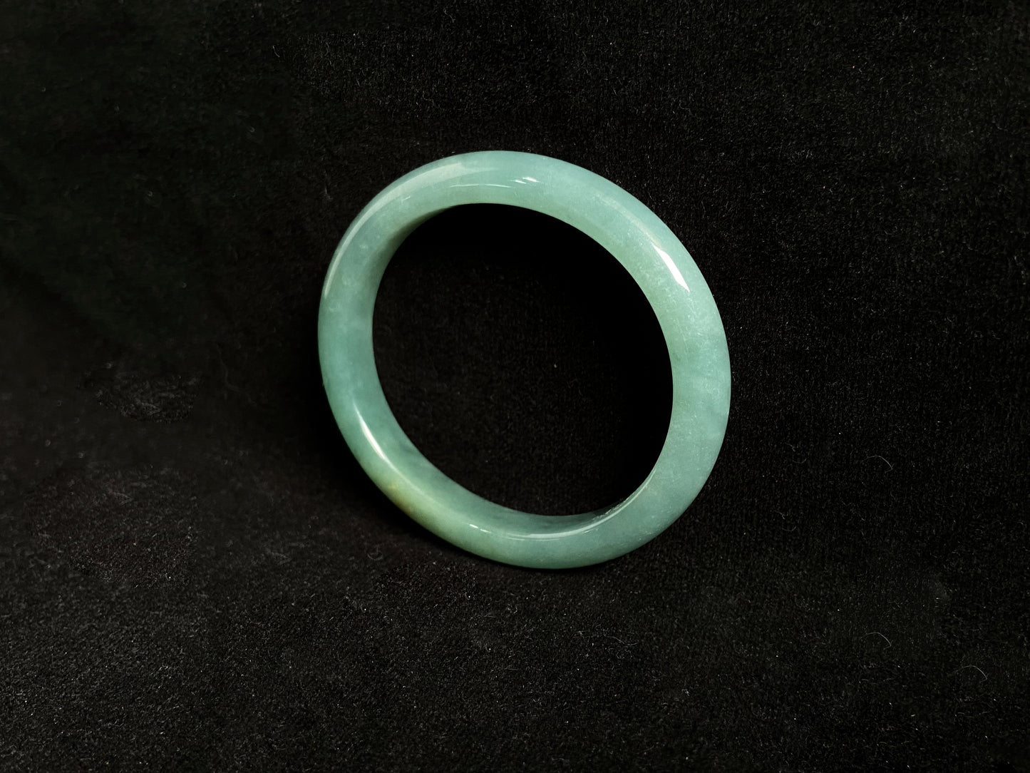 Deep green jade bangle with gold sprinkles.