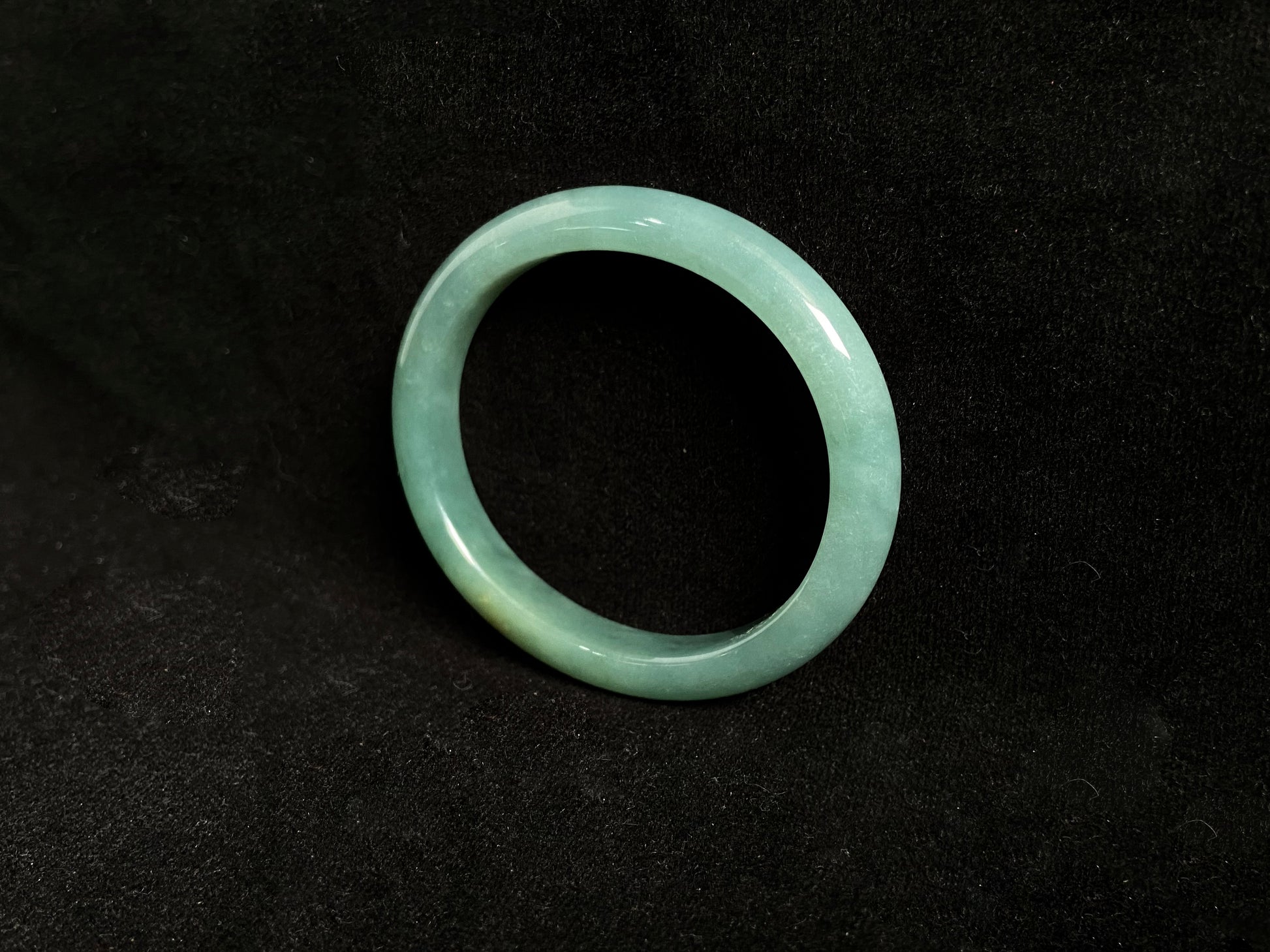 Deep green jade bangle with gold sprinkles.