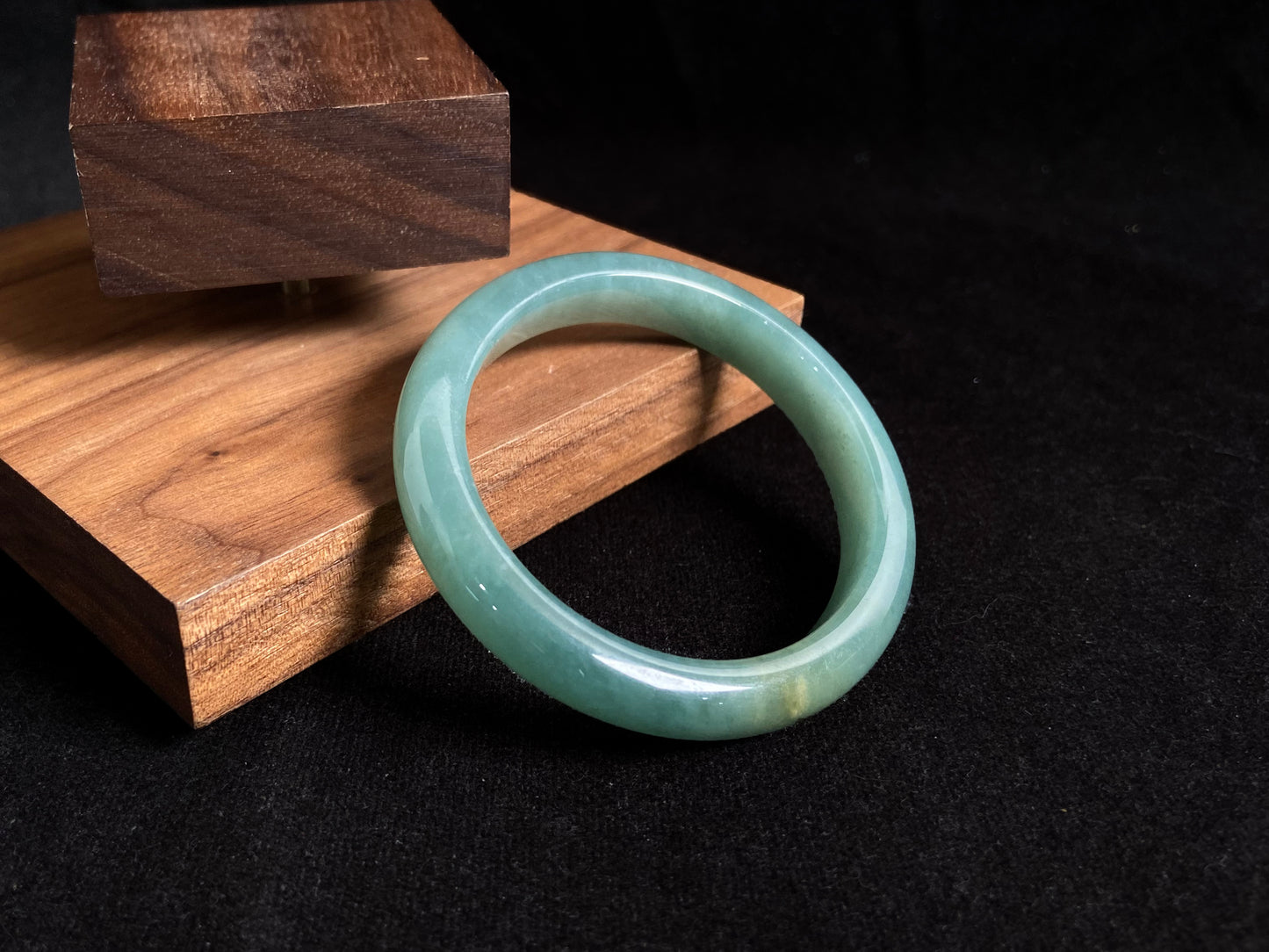 Deep green jade bangle with gold sprinkles.