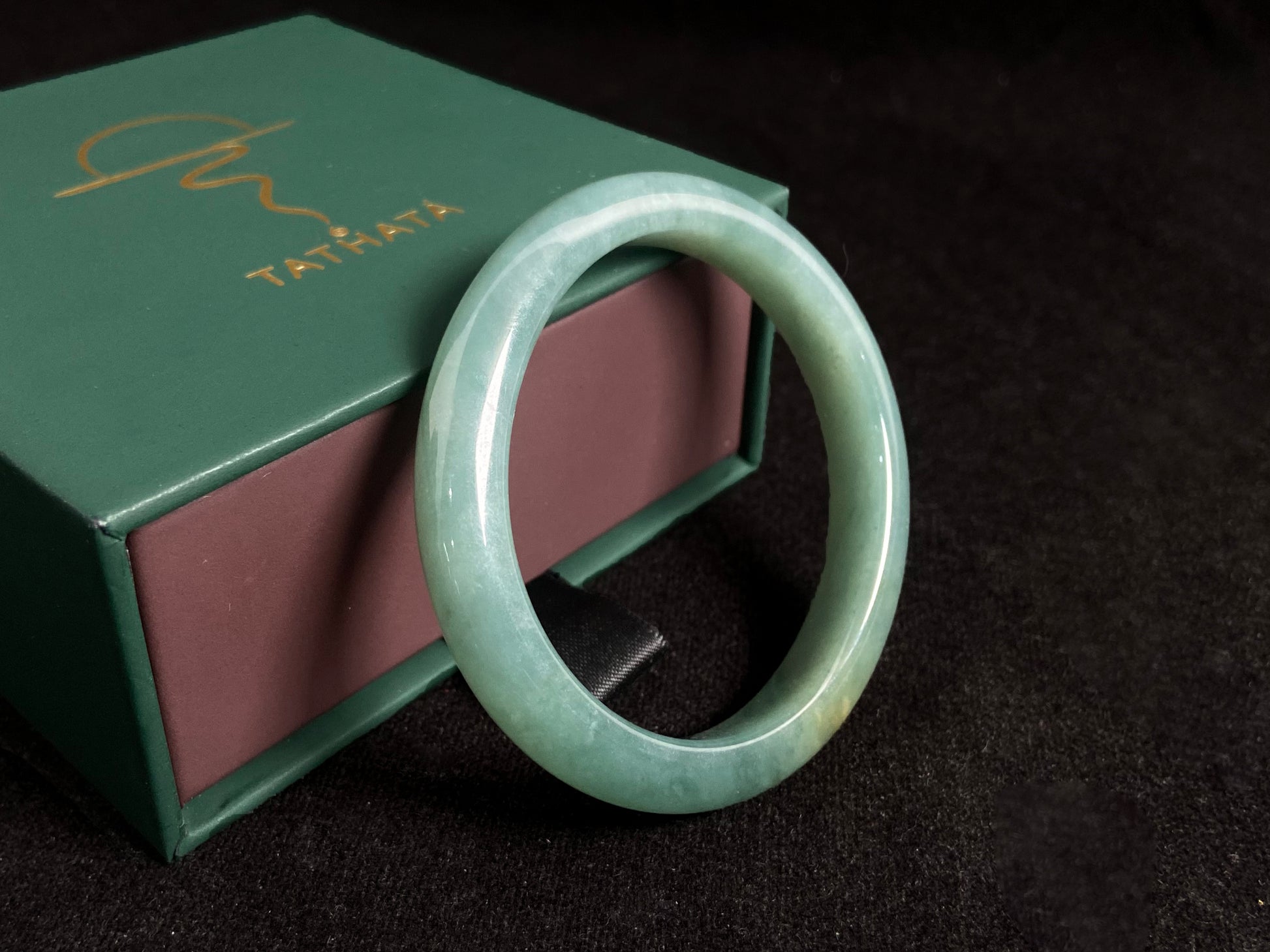 Deep green jade bangle with gold sprinkles.