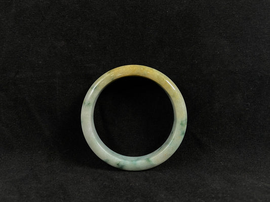 Green jade ring on a black background