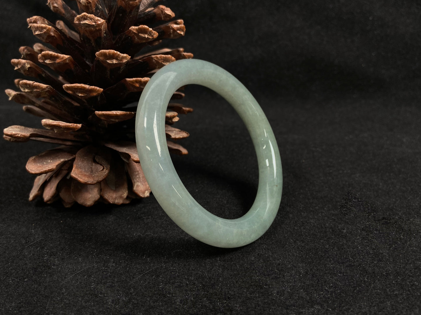 A semi-transparent, light green jadeite bangle.