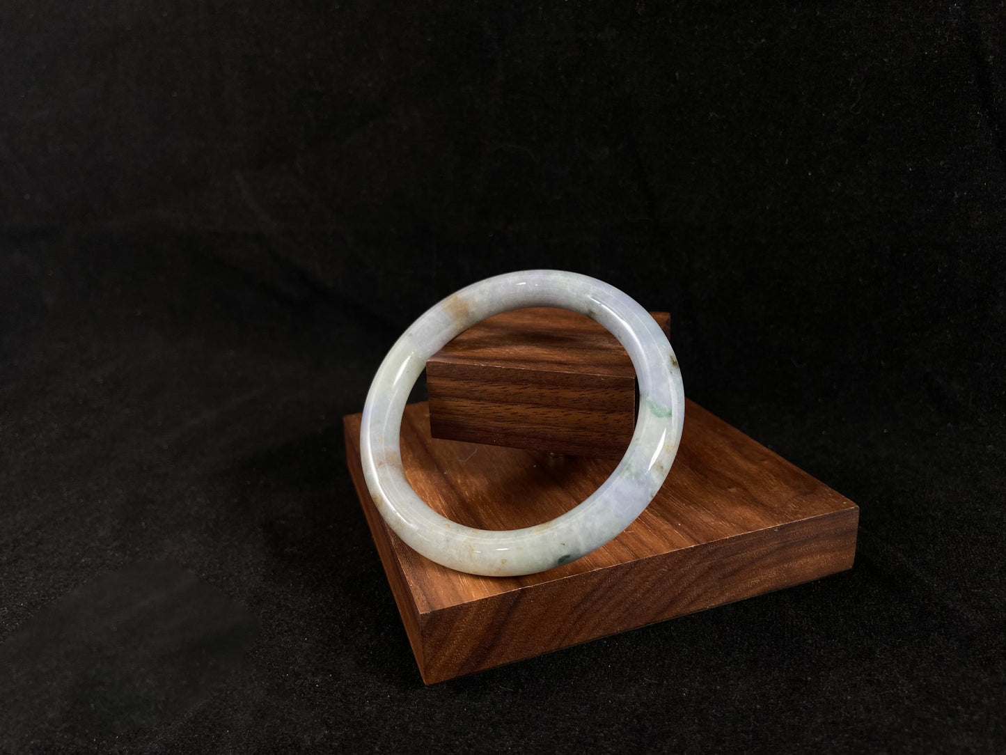 Golden jade ablaze with rainbow hues nestled in time-worn wood