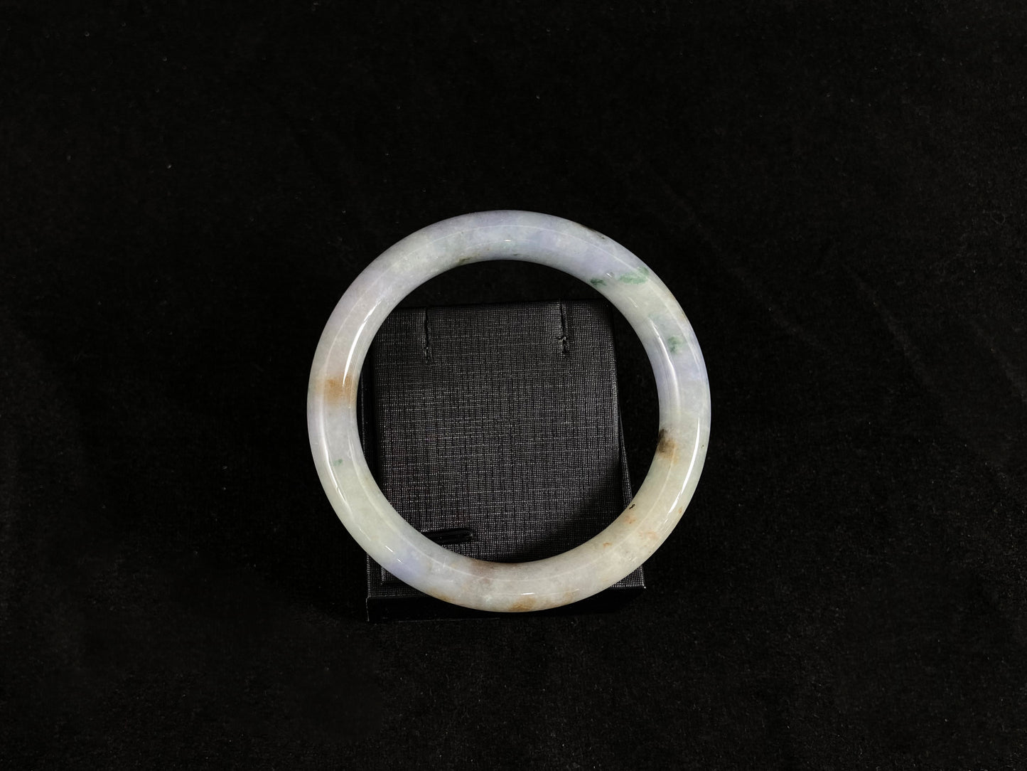 A multicolor jadeite bangle ablaze with nature's rainbow on gift box