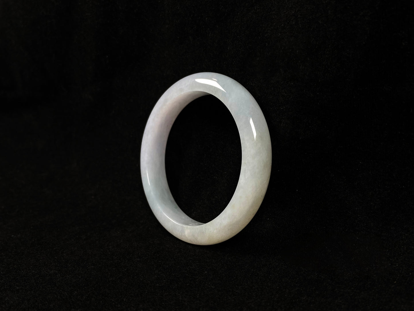 This creamy white jadeite bangle carries soft golden undertones, exuding warmth and elegance.