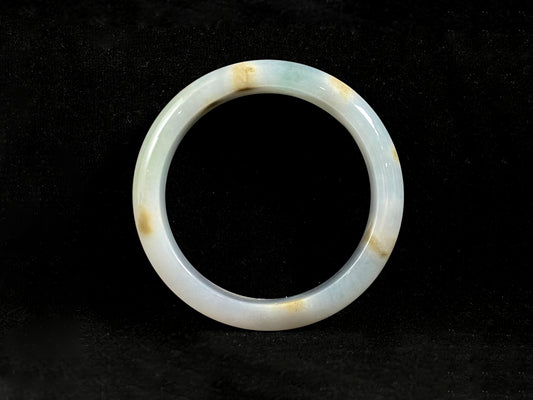 Natural ivory jade bangle with speckled gold and subtle green tones.