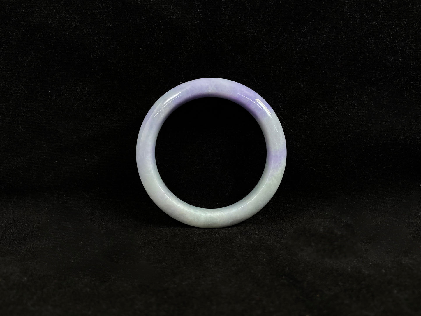 A white and purple jadeite bangle.