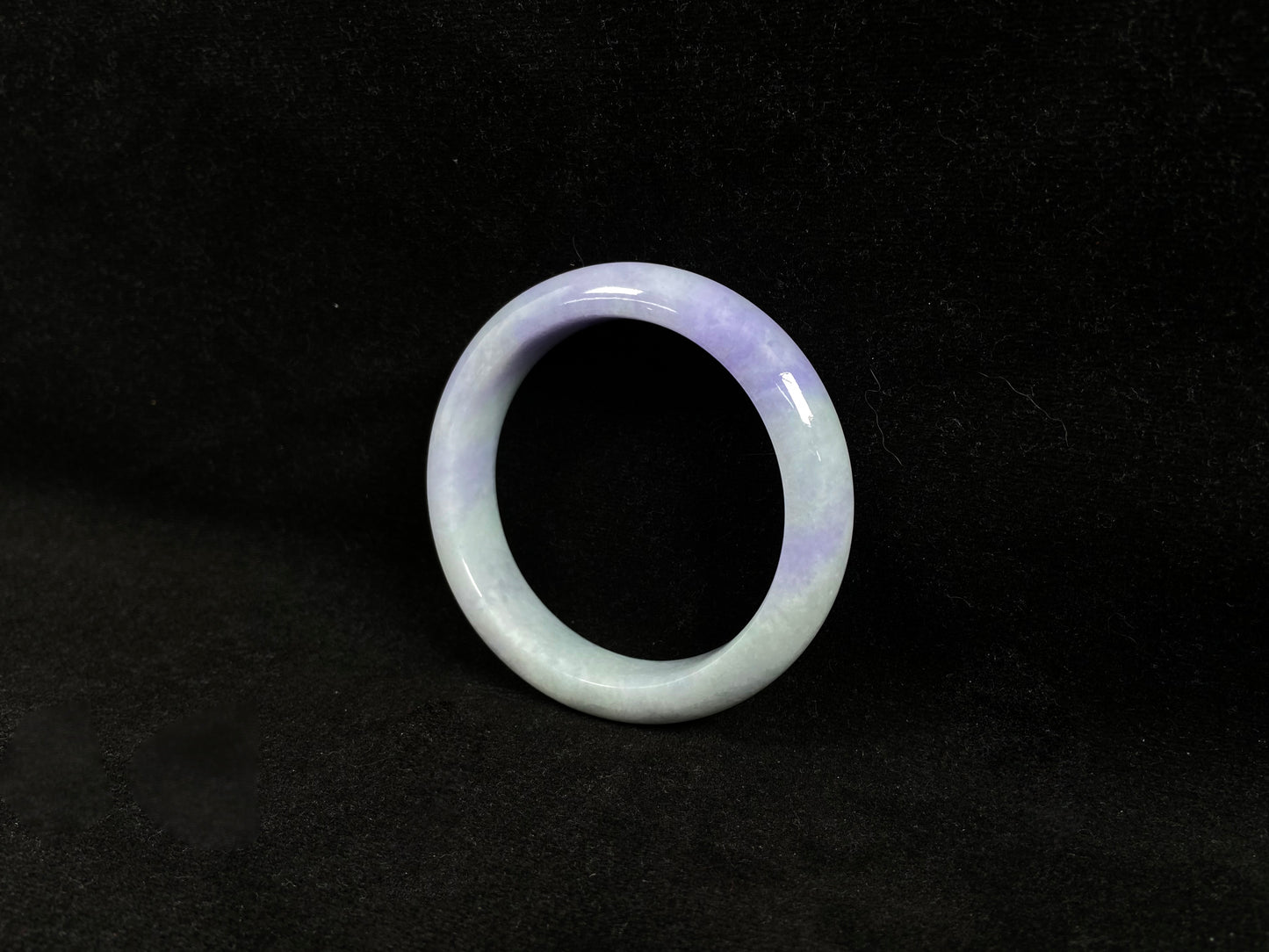 A white and purple jadeite bangle.