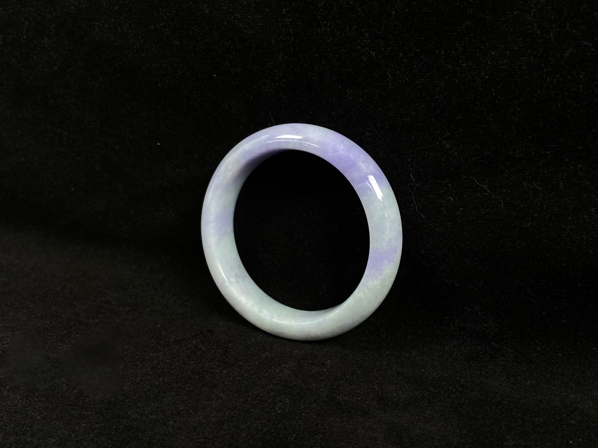 A white and purple jadeite bangle.