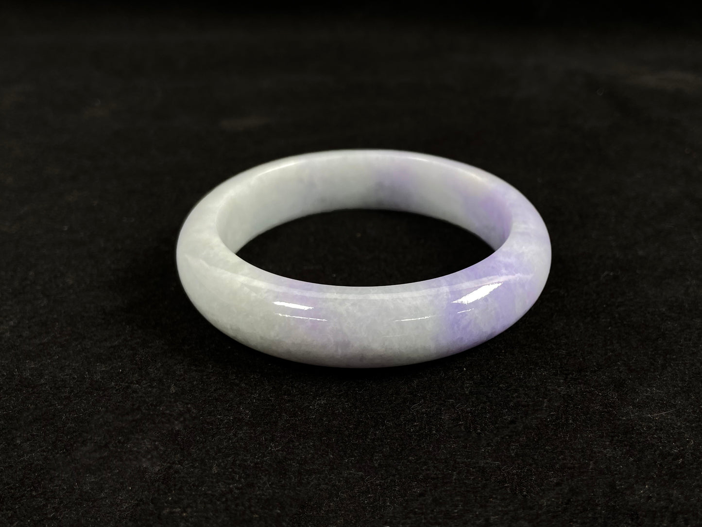 A white and purple jadeite bangle.