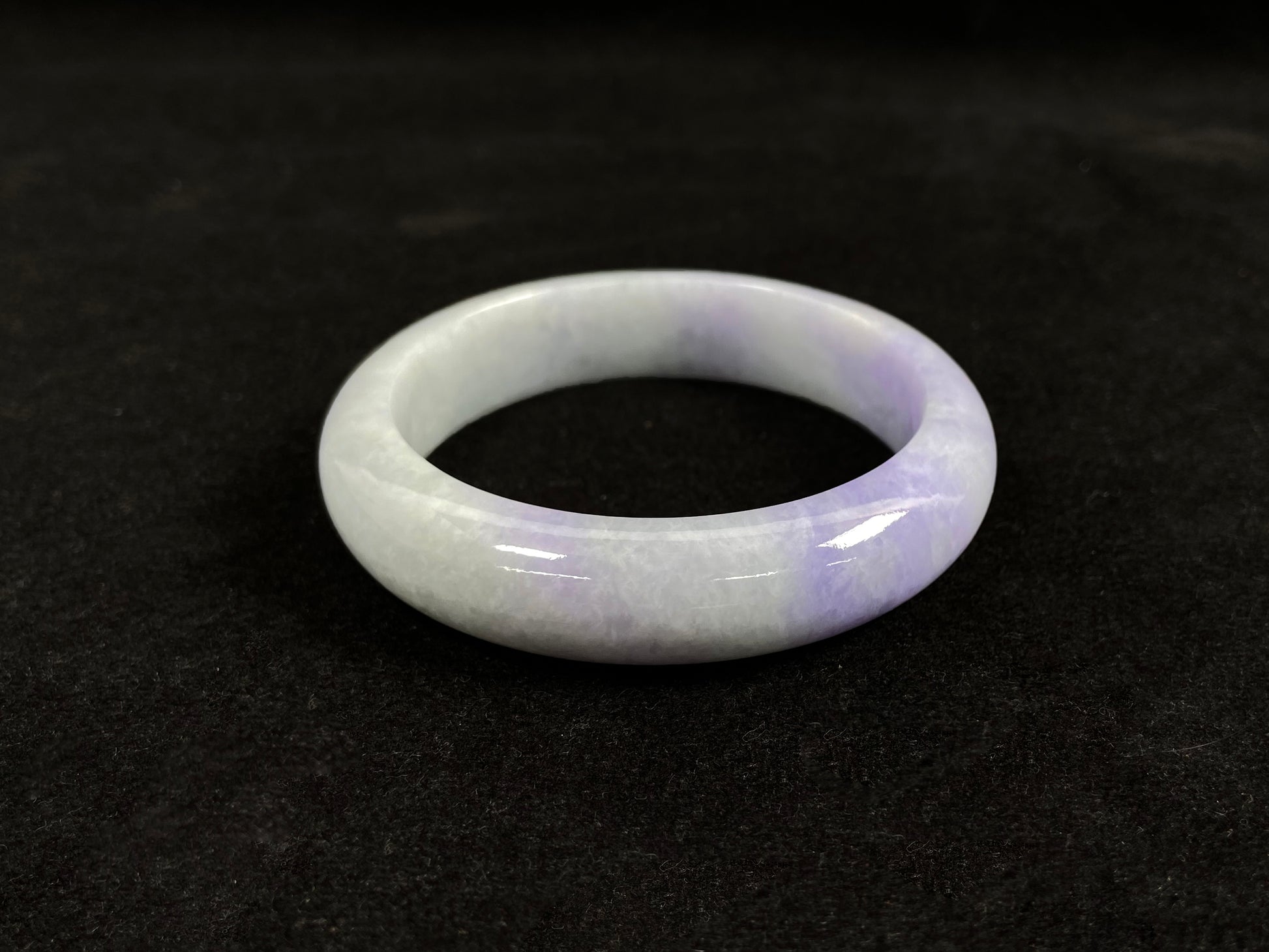 A white and purple jadeite bangle.