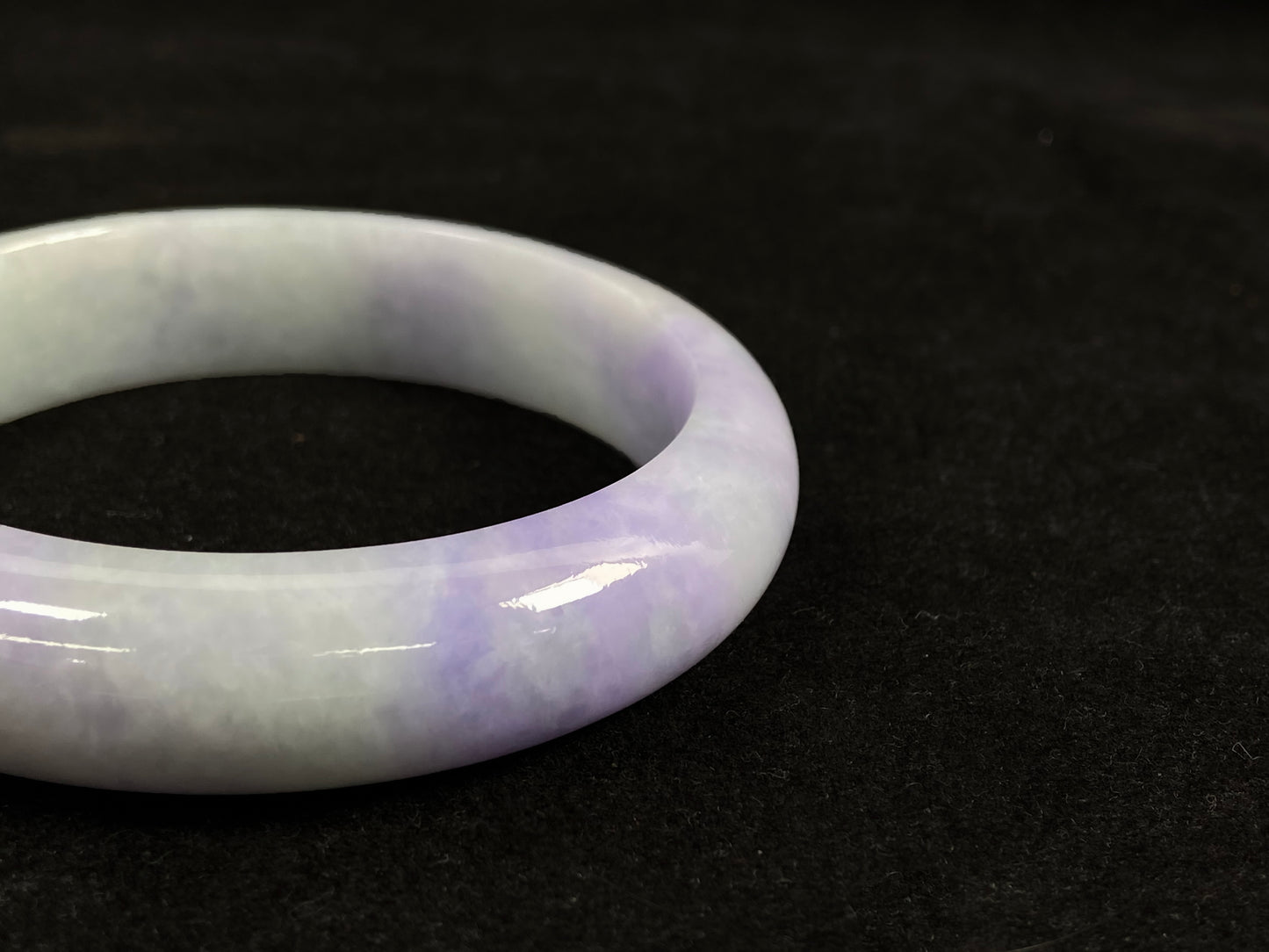 A white and purple jadeite bangle.
