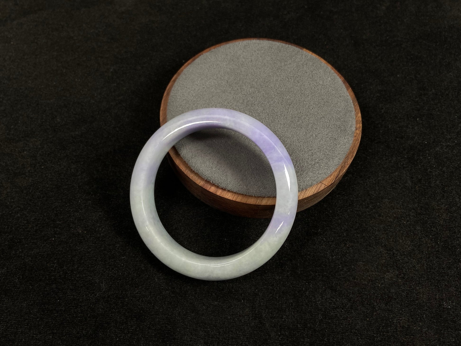 A white and purple jadeite bangle.
