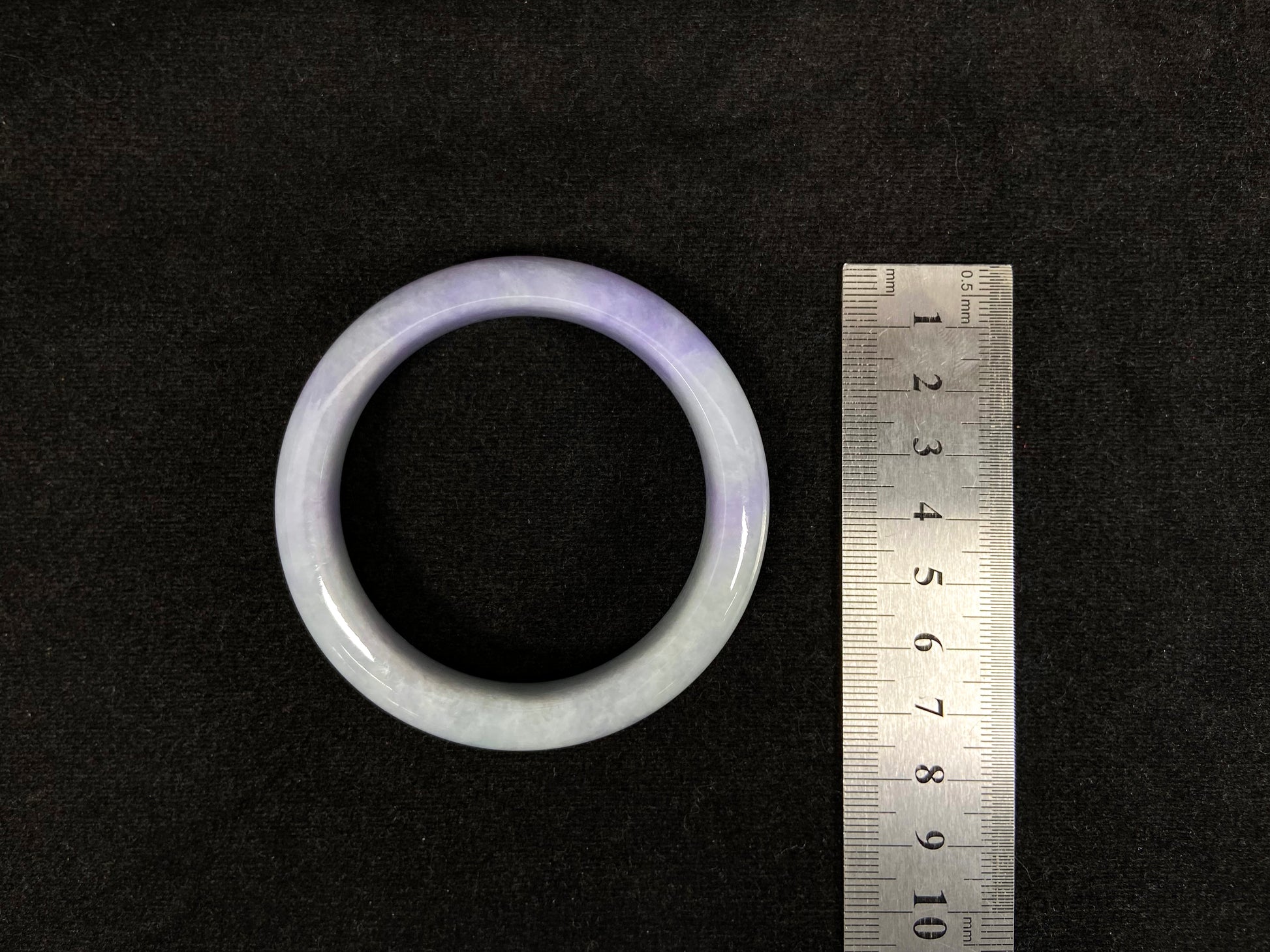 A white and purple jadeite bangle.