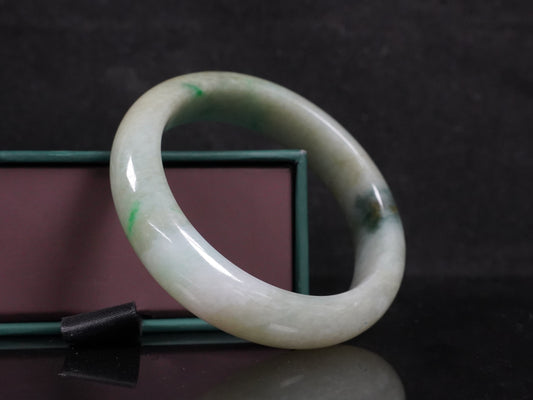 A soft greenish-aqua with natural veins  jadeite bangle.