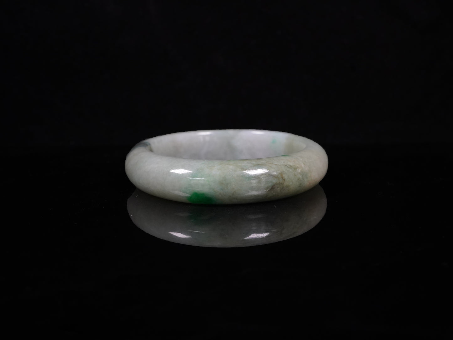 A soft greenish-aqua with natural veins  jadeite bangle.