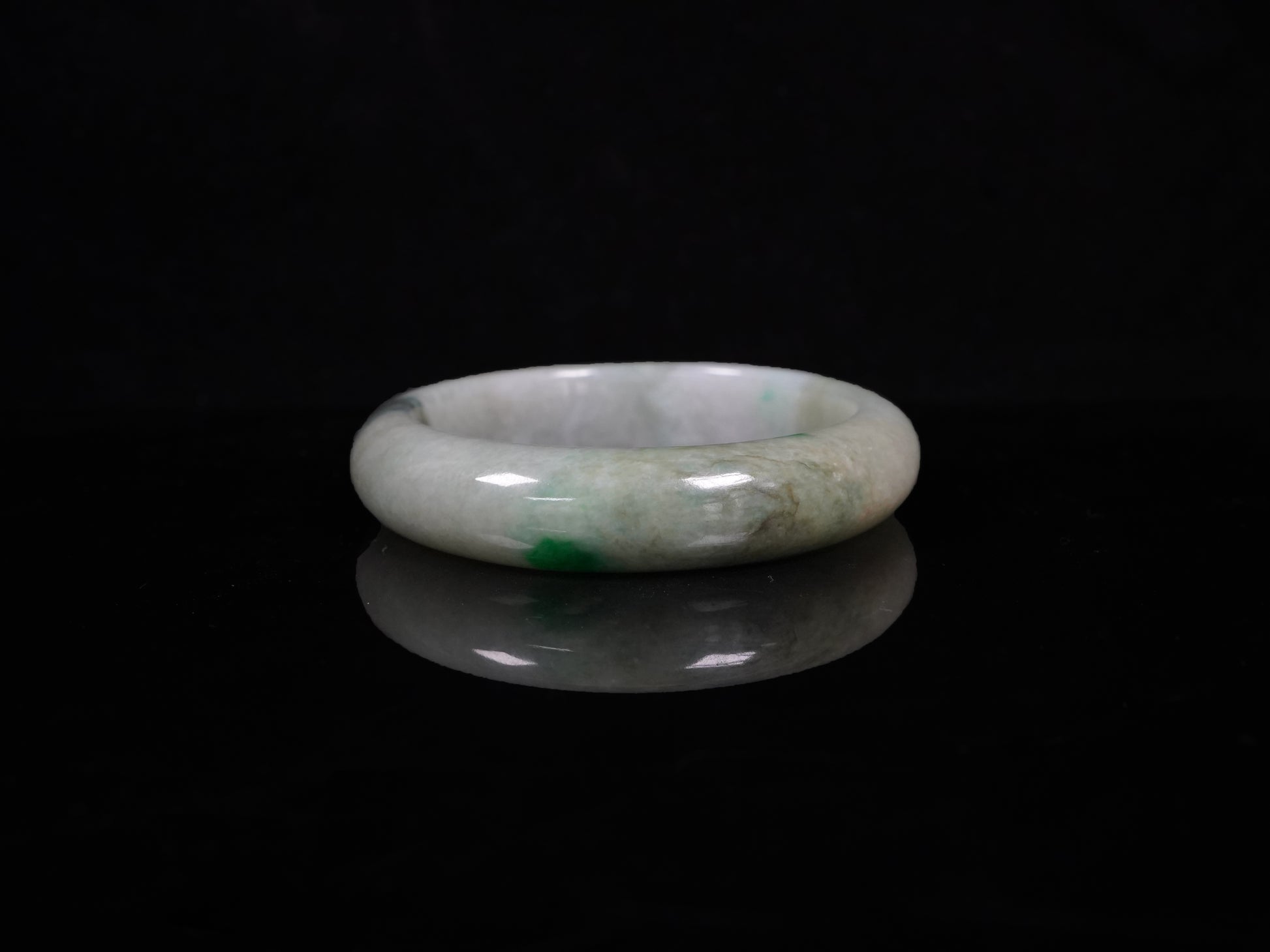 A soft greenish-aqua with natural veins  jadeite bangle.