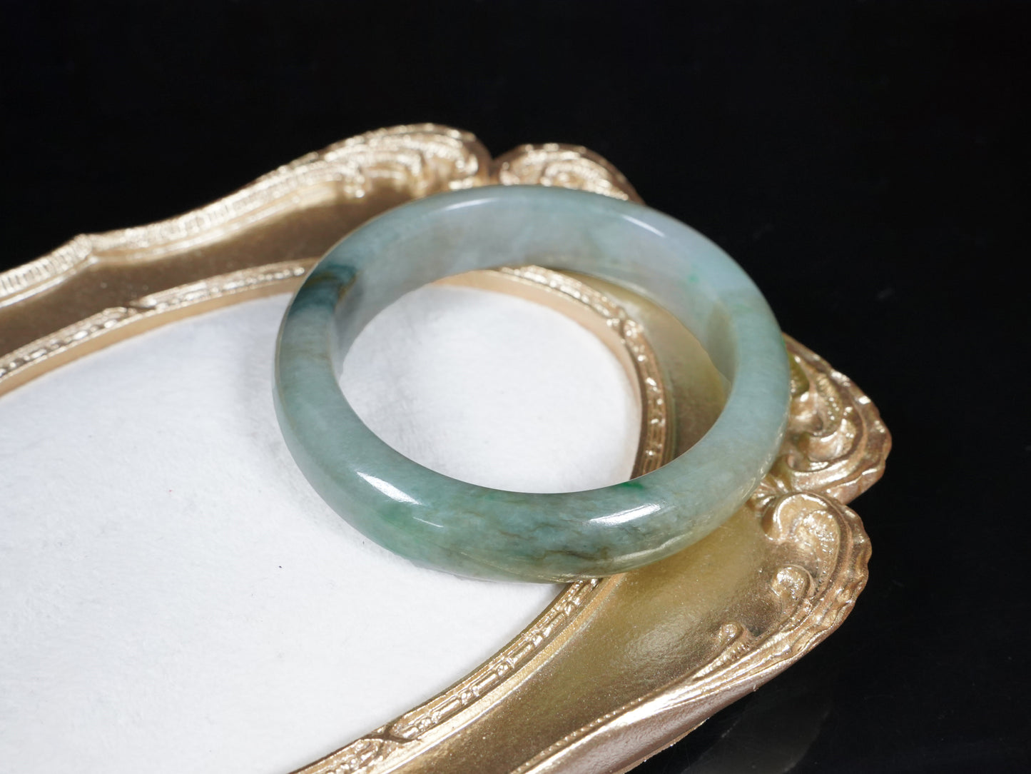 A soft greenish-aqua with natural veins  jadeite bangle.