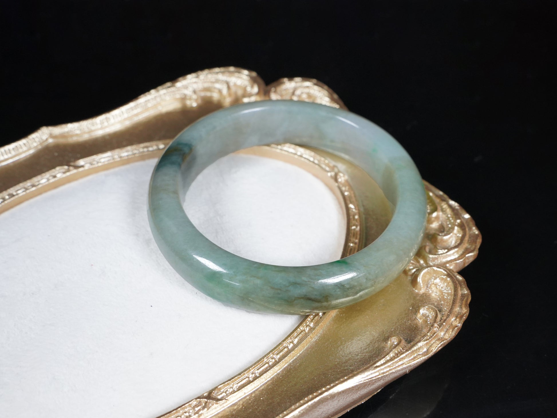 A soft greenish-aqua with natural veins  jadeite bangle.