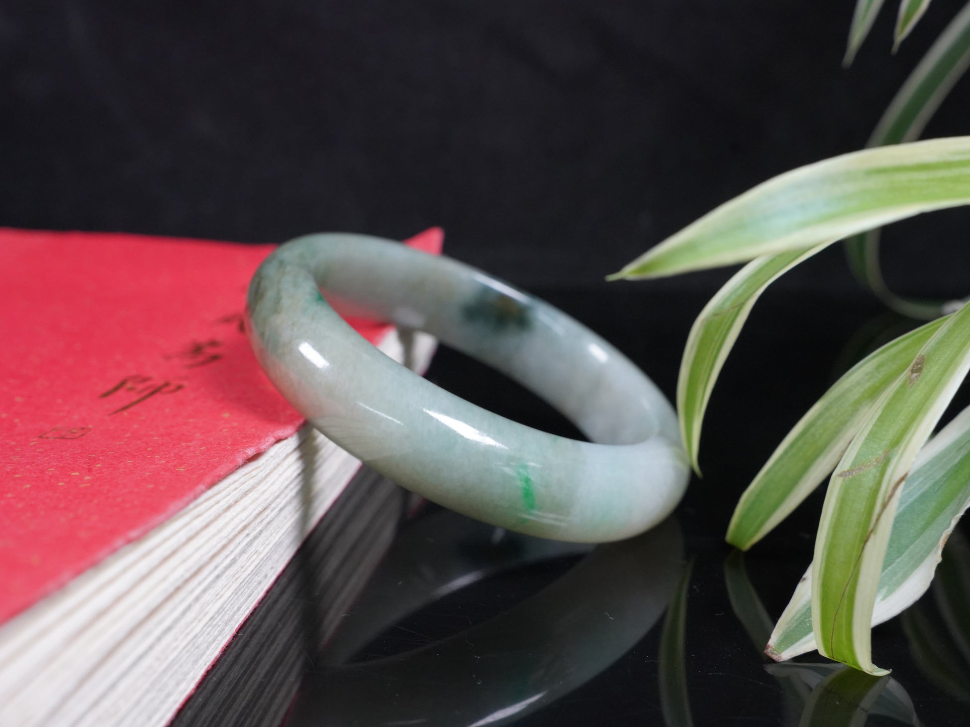 A soft greenish-aqua with natural veins  jadeite bangle.