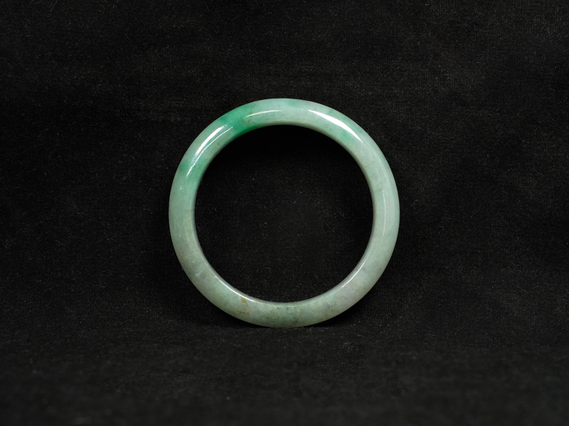 A misty green base, graced with floating deep green accents and a whisper of grey.