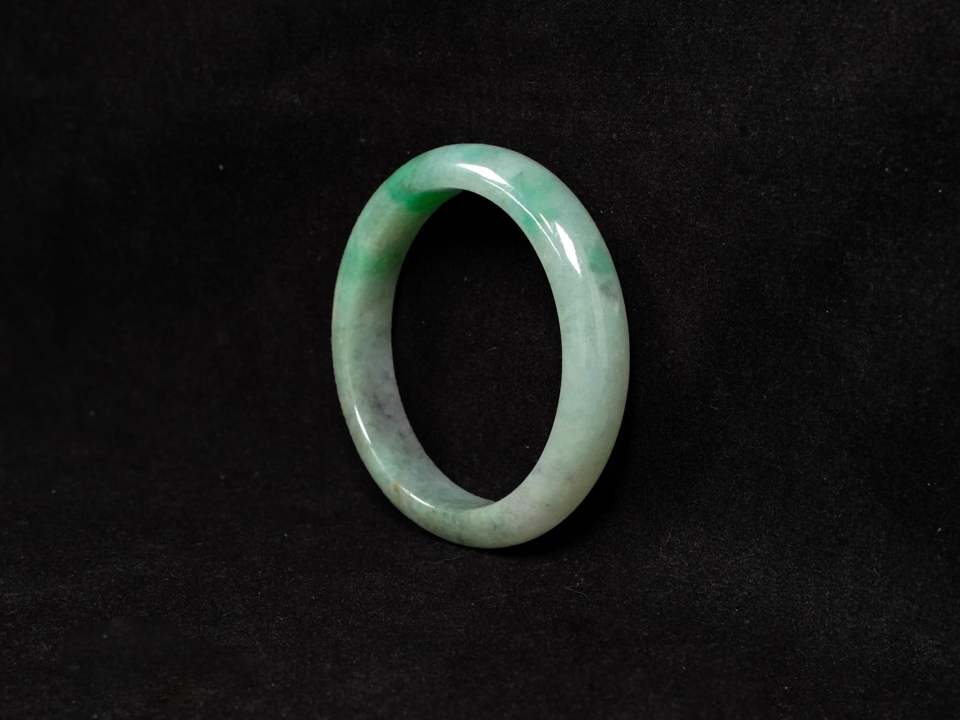 A misty green base, graced with floating deep green accents and a whisper of grey.