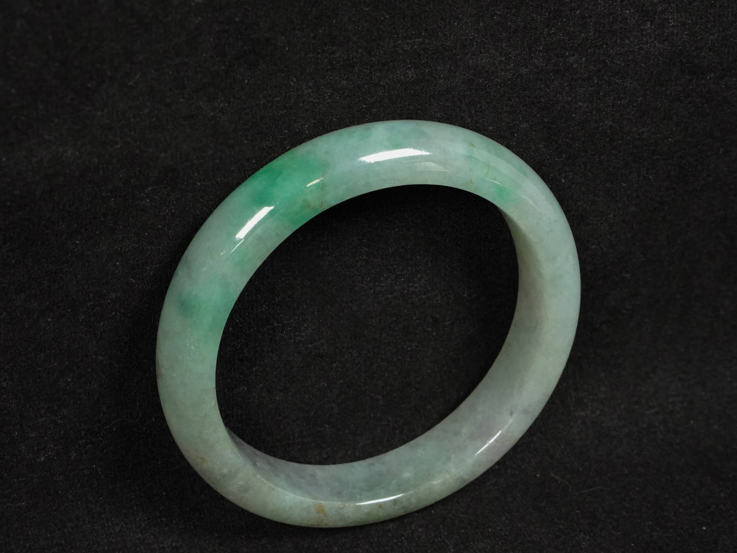 A misty green base, graced with floating deep green accents and a whisper of grey.