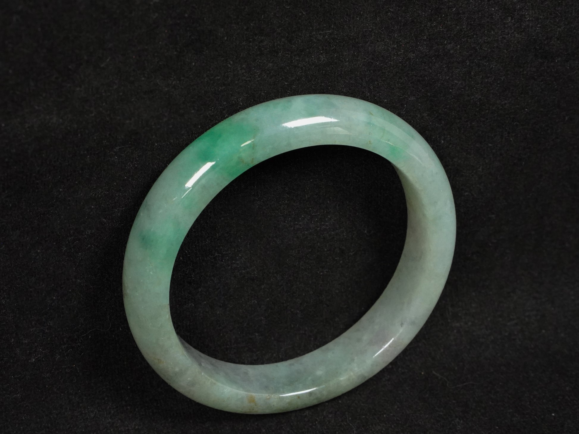 A misty green base, graced with floating deep green accents and a whisper of grey.