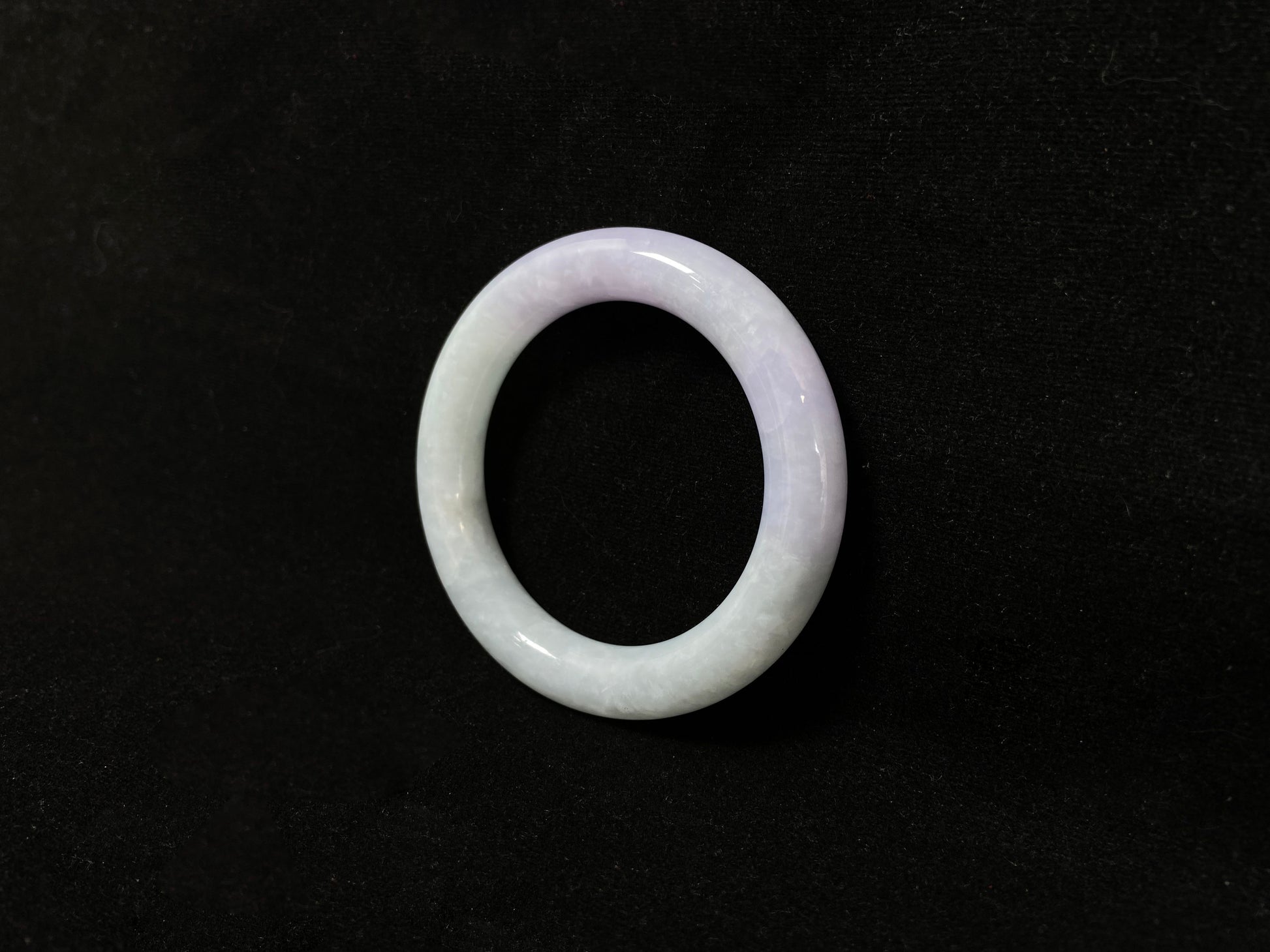 A Fu bangle featuring half light purple and half light green jade.
