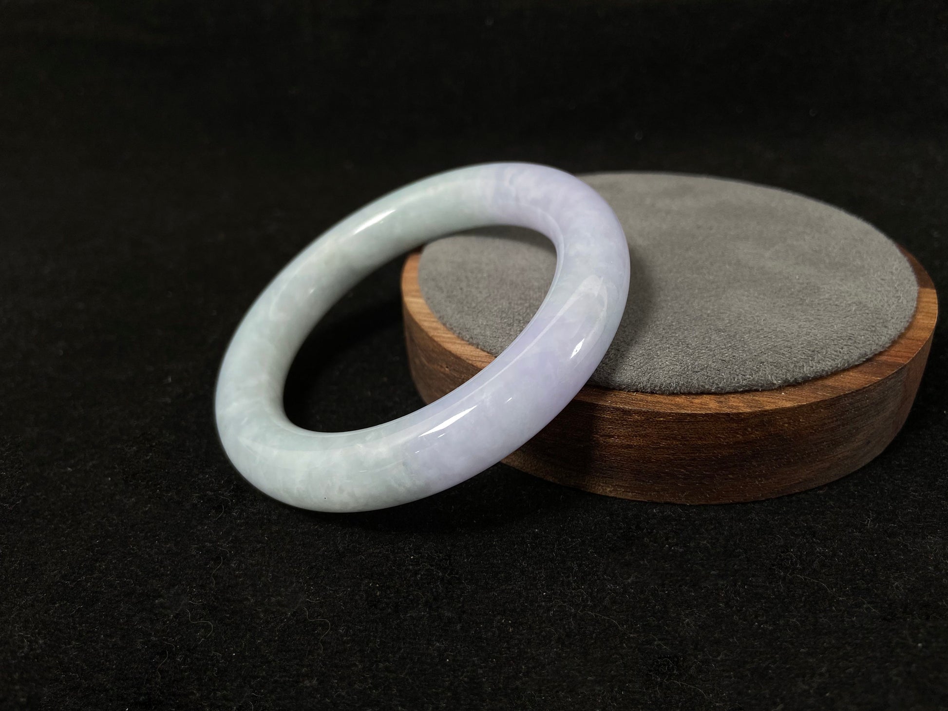 A Fu bangle featuring half light purple and half light green jade.