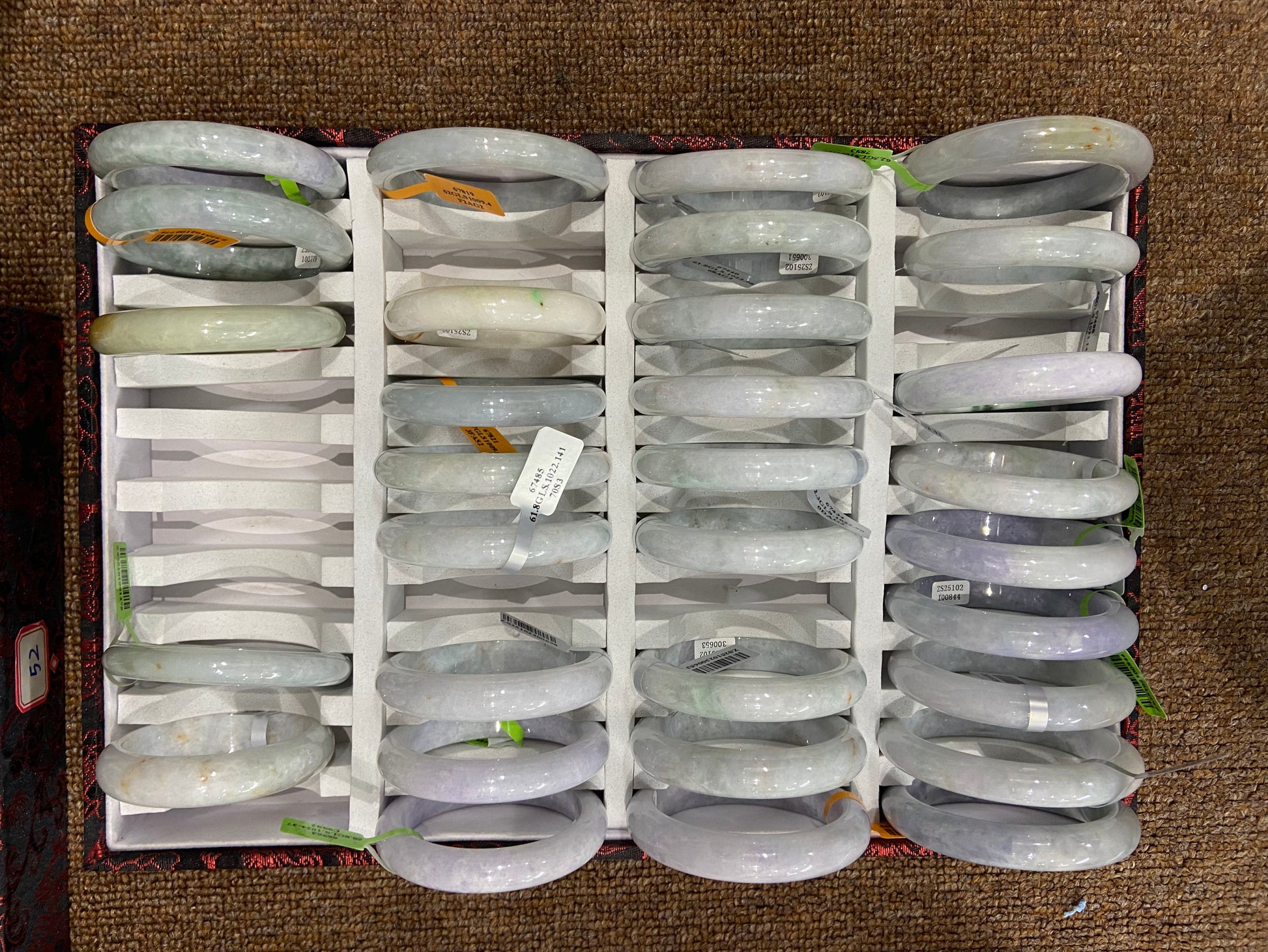 These bracelets were crafted from the same jadeite block, featuring golden and purple hues.