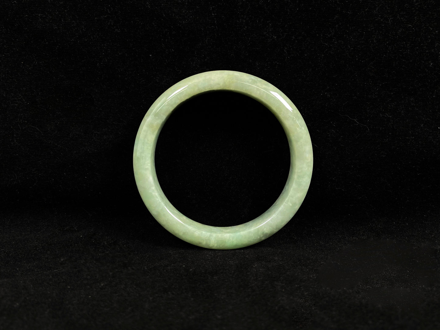 A soothing pea green jade bangle.