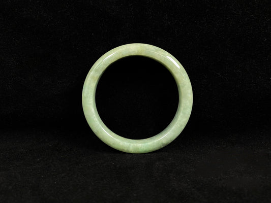 A soothing pea green jade bangle.