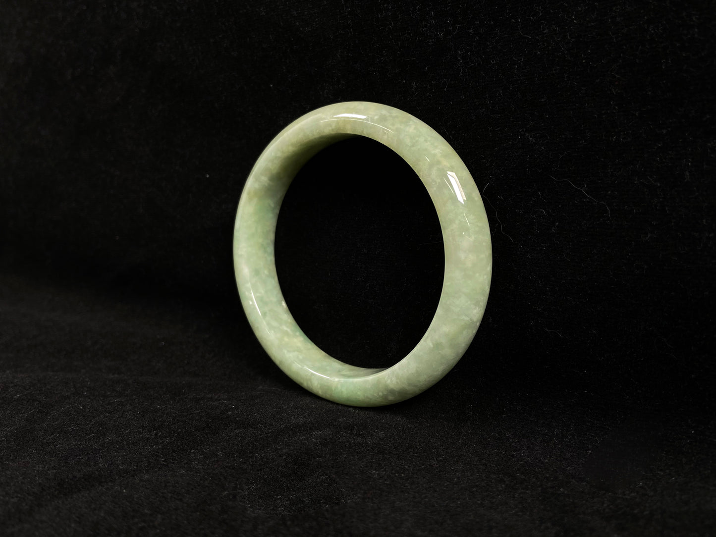 A soothing pea green jade bangle.