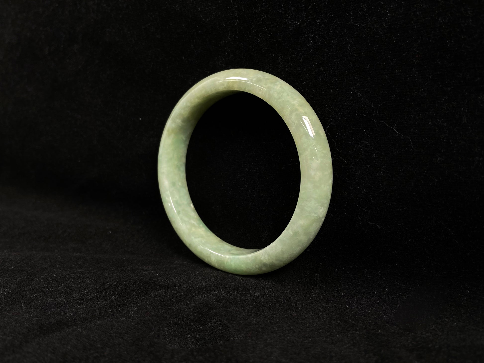 A soothing pea green jade bangle.
