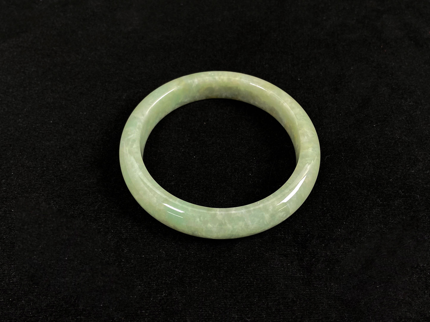 A soothing pea green jade bangle.