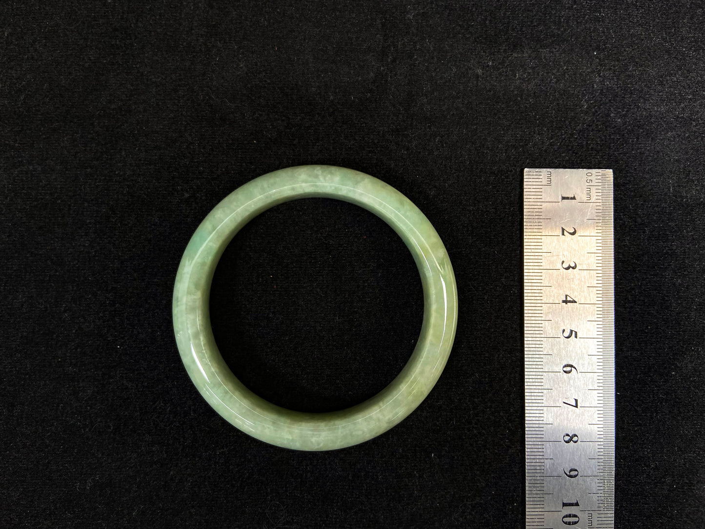 A soothing pea green jade bangle.