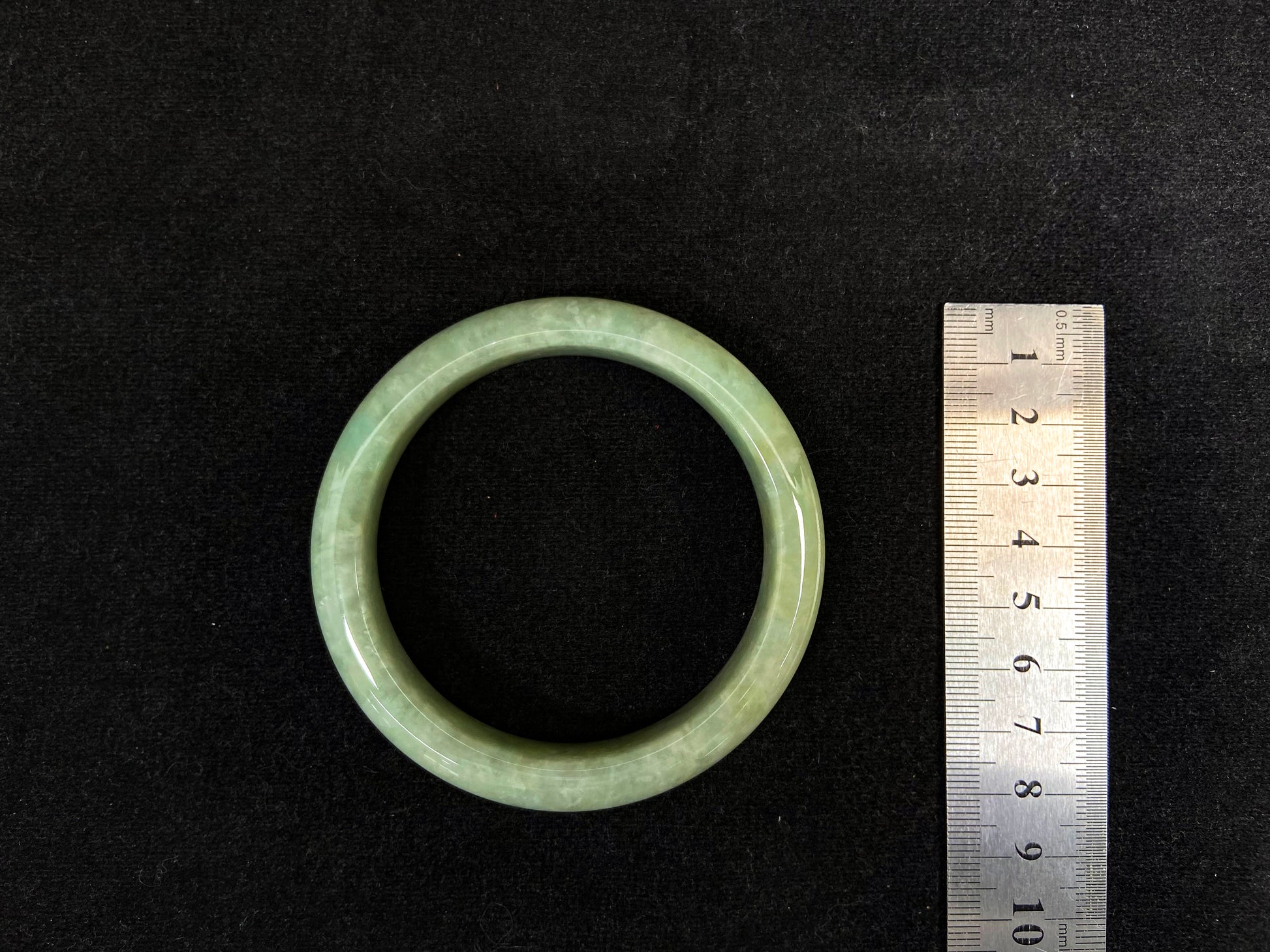 A soothing pea green jade bangle.